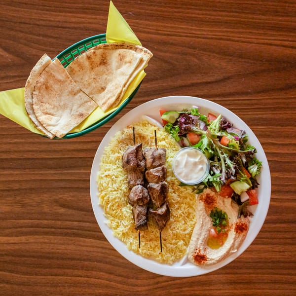 Zest Mediterranean Cuisine's beef shish kebab plate with rice, salad, hummus, and pita bread.